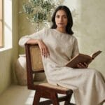 Guest seated on the Chandigarh cane dining chair in a sunlit interior