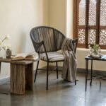 Curve outdoor rope chair styled beside a side table in a terrace setting