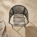 Curve outdoor chair front view on a stone terrace
