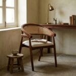 Derby cane dining chair at a wooden desk in a warm interior