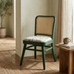 Goa green wooden dining chair styled beside a side table
