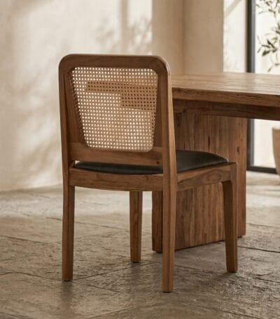 Moon cane dining chair at a solid wood dining table