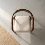Neerja dining armchair front view showing the curved backrest