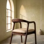 Rena wooden dining chair in a warm arched interior