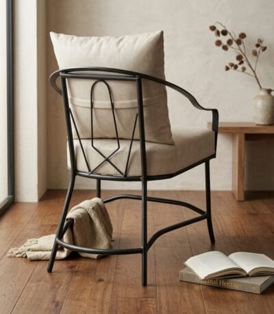 Ross metal arm chair styled beside a side table on a wooden floor