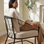 Ross metal arm chair with cushions in a garden-facing setting